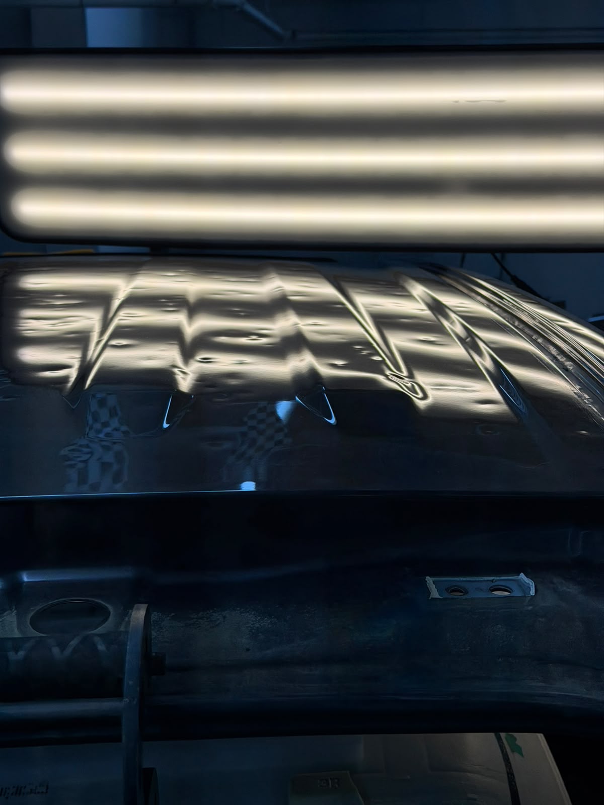 Vehicle hood with hail damage