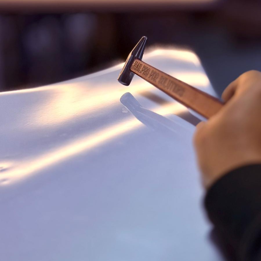 Technician performing paintless dent repair